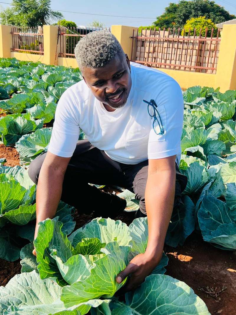 Chef Andile Somdaka among the cabbage rows at a local farm