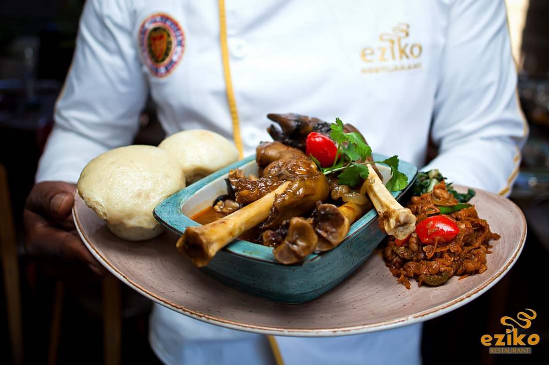 Chef Andile presenting a plated lamb shank dish